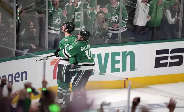 Dallas Stars left wing Mason Marchment, left, and Ty Dellandrea (10) celebrate after Marchment scored against the Edmonton Oilers during the third period in Game 2 of the Western Conference finals in the NHL hockey Stanley Cup playoffs Saturday, May 25, 2024, in Dallas. (AP Photo/Tony Gutierrez)