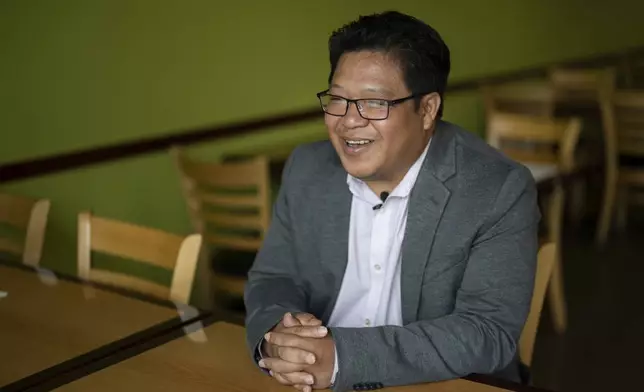 Cayle Tern, president of the Iu Mien Association of Oregon, speaks during an interview with The Associated Press at Chiang Rai Thai Cuisine on Tuesday, April 30, 2024, in Troutdale, Ore. Tern arrived in Portland with his family in 1980, when he was 3 years old. He is now running for City Council. His father and uncle assisted American forces in Laos and he was born as his mother fled to a refugee camp in Thailand. (AP Photo/Jenny Kane)