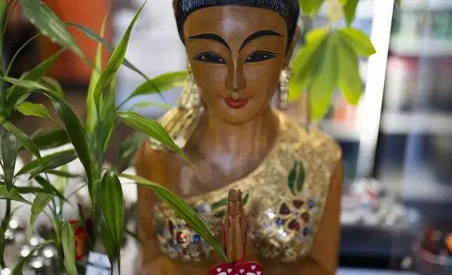 A statue is seen at Chiang Rai Thai Cuisine, a family restaurant run by members of the Iu Mien community, on Tuesday, April 30, 2024, in Troutdale, Ore. There is a sizeable Iu Mien community in Portland and its suburbs, with a Buddhist temple and Baptist church, active social organization, and businesses and restaurants. (AP Photo/Jenny Kane)