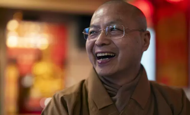 Monk Dauv Singx Si laughs at the Iu Mien Buddha Light Temple on Tuesday, April 30, 2024, in Gresham, Ore. There is a sizeable Iu Mien community in Portland and its suburbs, with a Buddhist temple and Baptist church, active social organization, and businesses and restaurants. (AP Photo/Jenny Kane)