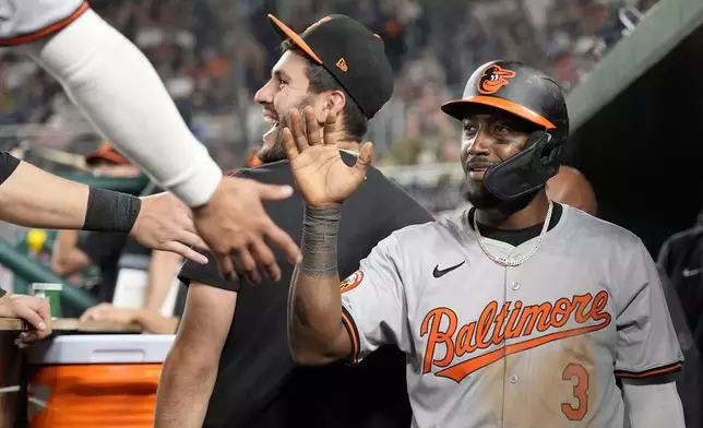 Baltimore Orioles' Jorge Mateo (3) is congratulated by his teammates after scoring against the Washington National in the 12th inning of a baseball game at Nationals Park in Washington, Wednesday, May 8, 2024. (AP Photo/Susan Walsh)