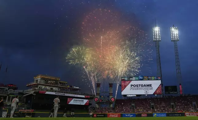 Fireworks explode above the Great American Ball Park before a baseball game between the Baltimore Orioles and the Cincinnati Reds, Friday, May 3, 2024, in Cincinnati. The postgame fireworks were fired before the game because of the rain delay. (AP Photo/Carolyn Kaster)