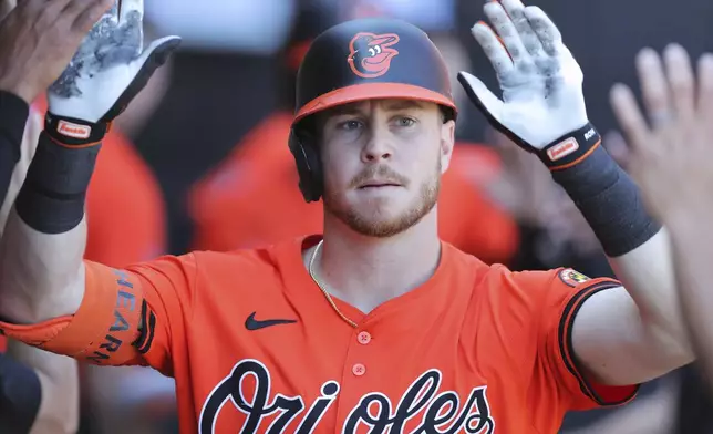 Baltimore Orioles' Ryan O'Hearn celebrates in the dugout after hitting a two-run home run during the eighth inning of a baseball game against the Chicago White Sox, Saturday, May 25, 2024, in Chicago. (AP Photo/Melissa Tamez)