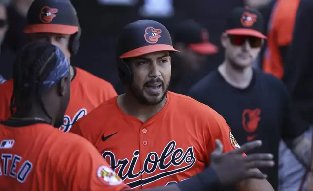 Baltimore Orioles' Anthony Santander, center, celebrates after hitting a two-run home run during the eighth inning of a baseball game against the Chicago White Sox, Saturday, May 25, 2024, in Chicago. (AP Photo/Melissa Tamez)