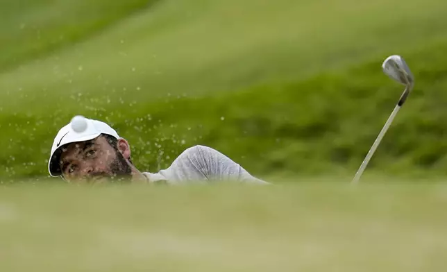 Scottie Scheffler hits from the bunker on the 10th hole during the third round of the PGA Championship golf tournament at the Valhalla Golf Club, Saturday, May 18, 2024, in Louisville, Ky. (AP Photo/Sue Ogrocki)