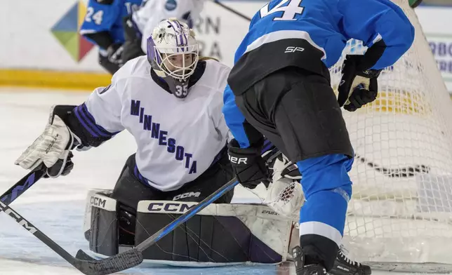 Minnesota goaltender Maddie Rooney (35) makes a save on Toronto's Hannah Miller (34) during the second period of a PWHL hockey game in Toronto on Wednesday May 1, 2024. (Frank Gunn/The Canadian Press via AP)