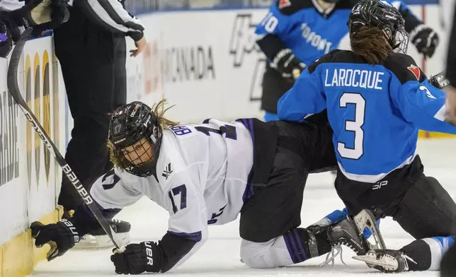 Toronto's Jocelyne Laroque (3) and Minnesota's Brooke Bryant (17) tumble during the first period of a PWHL hockey game in Toronto on Wednesday, May 1, 2024. (Frank Gunn/The Canadian Press via AP)