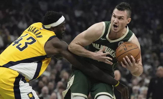 Indiana Pacers' Pascal Siakam fouls Milwaukee Bucks' Danilo Gallinari during the first half of Game 5 of the NBA playoff basketball series Tuesday, April 30, 2024, in Milwaukee. (AP Photo/Morry Gash)