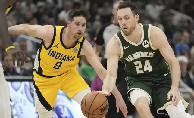 Milwaukee Bucks' Pat Connaughton gets past Indiana Pacers' T.J. McConnell during the first half of Game 5 of the NBA playoff basketball series Tuesday, April 30, 2024, in Milwaukee. (AP Photo/Morry Gash)