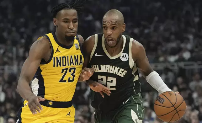 Milwaukee Bucks' Khris Middleton tries to get past Indiana Pacers' Aaron Nesmith during the first half of Game 5 of the NBA playoff basketball series Tuesday, April 30, 2024, in Milwaukee. (AP Photo/Morry Gash)