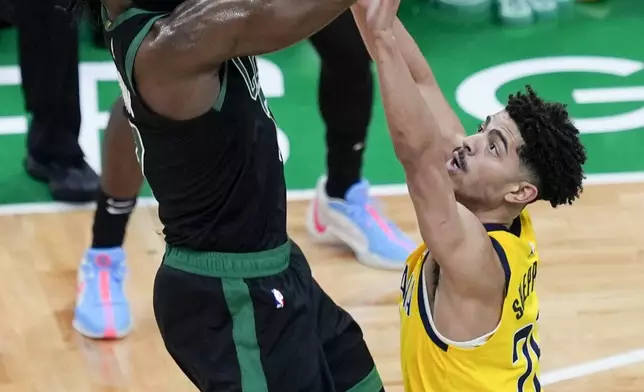 Boston Celtics guard Jaylen Brown, left, shoots over Indiana Pacers guard Ben Sheppard (26) during the second half of Game 2 of the NBA Eastern Conference basketball finals Thursday, May 23, 2024, in Boston. (AP Photo/Michael Dwyer)