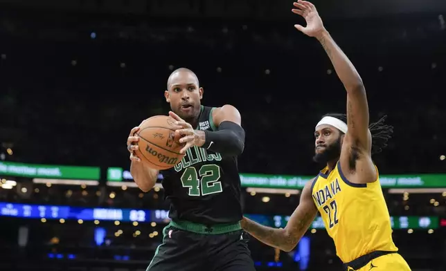 Boston Celtics center Al Horford (42) grabs a rebound next to Indiana Pacers forward Isaiah Jackson (22) during the second half of Game 2 of the NBA Eastern Conference basketball finals Thursday, May 23, 2024, in Boston. (AP Photo/Steven Senne)