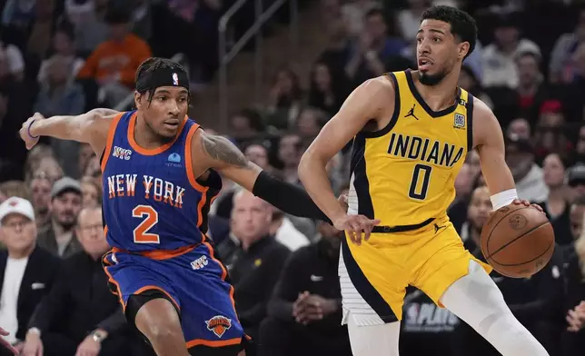New York Knicks' Miles McBride (2) defends Indiana Pacers' Tyrese Haliburton (0) during the first half of Game 5 in an NBA basketball second-round playoff series, Tuesday, May 14, 2024, in New York. (AP Photo/Frank Franklin II)