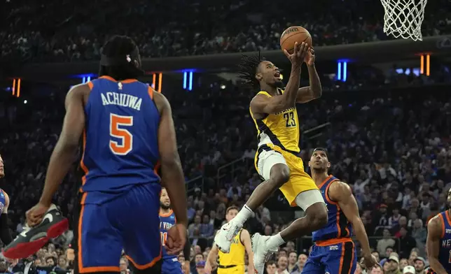 Indiana Pacers' Aaron Nesmith (23) drives past New York Knicks' Josh Hart and Precious Achiuwa (5) during the first half of Game 5 in an NBA basketball second-round playoff series, Tuesday, May 14, 2024, in New York. (AP Photo/Frank Franklin II)