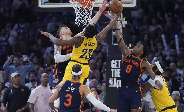 New York Knicks' OG Anunoby (8) and Isaiah Hartenstein (55) defend against a shot by Indiana Pacers' Aaron Nesmith (23) during the second half of Game 2 in an NBA basketball second-round playoff series Wednesday, May 8, 2024, in New York. The Knicks won 130-121. (AP Photo/Frank Franklin II)