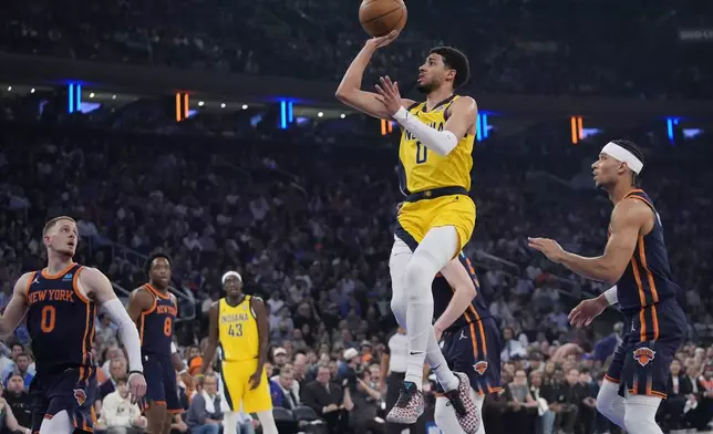 Indiana Pacers' Tyrese Haliburton drives past New York Knicks' Josh Hart, right, during the first half of Game 2 in an NBA basketball second-round playoff series Wednesday, May 8, 2024, in New York. (AP Photo/Frank Franklin II)