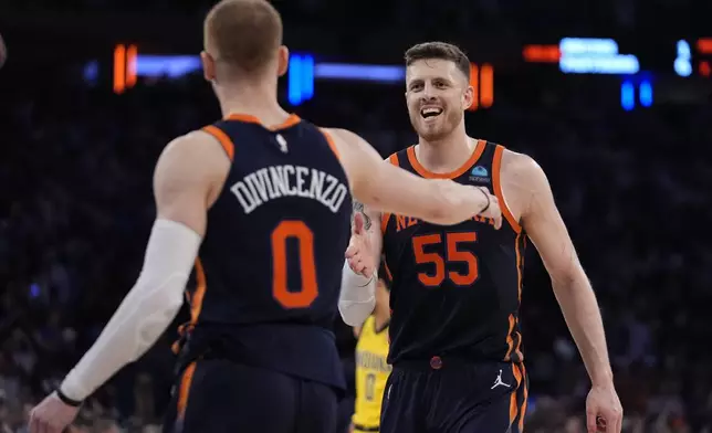 New York Knicks' Isaiah Hartenstein (55) celebrates with Donte DiVincenzo (0) during the second half of Game 2 in an NBA basketball second-round playoff series against the Indiana Pacers, Wednesday, May 8, 2024, in New York. The Knicks won 130-121. (AP Photo/Frank Franklin II)