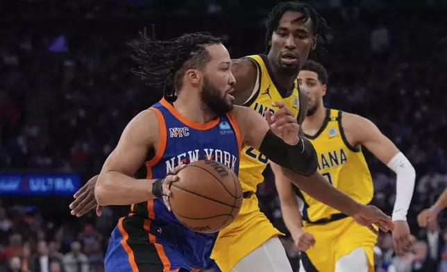 New York Knicks' Jalen Brunson, left, drives past Indiana Pacers' Aaron Nesmith during the second half of Game 5 in an NBA basketball second-round playoff series, Tuesday, May 14, 2024, in New York. The Knicks won 121-91. (AP Photo/Frank Franklin II)