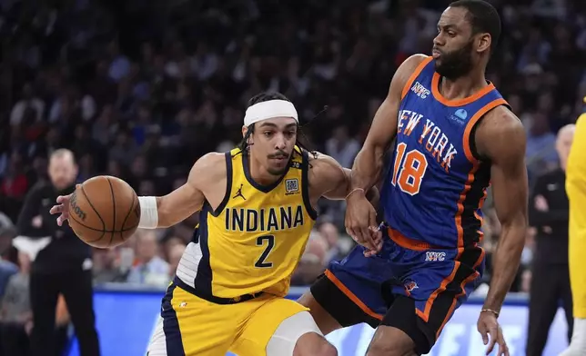 Indiana Pacers' Andrew Nembhard (2) drives past New York Knicks' Alec Burks (18) during the first half of Game 5 in an NBA basketball second-round playoff series, Tuesday, May 14, 2024, in New York. (AP Photo/Frank Franklin II)
