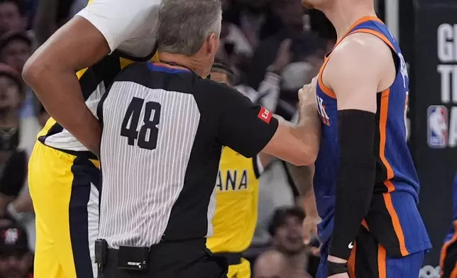 referee Scott Foster (48) gets in between Indiana Pacers' Myles Turner, left, and New York Knicks' Donte DiVincenzo during the second half of Game 5 in an NBA basketball second-round playoff series, Tuesday, May 14, 2024, in New York. The Knicks won 121-91. (AP Photo/Frank Franklin II)