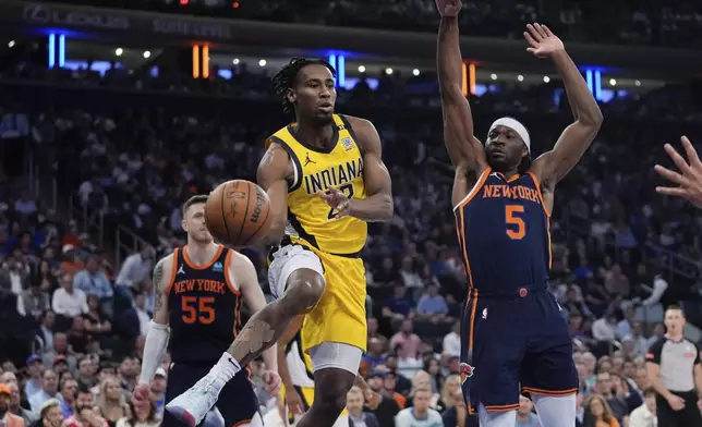 Indiana Pacers' Aaron Nesmith (23) passes the ball away from New York Knicks' Precious Achiuwa (5) during the first half of Game 2 in an NBA basketball second-round playoff series Wednesday, May 8, 2024, in New York. (AP Photo/Frank Franklin II)