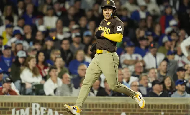 San Diego Padres' Ha-Seong Kim scores on a three-run double by Luis Campusano during the sixth inning of a baseball game against the Chicago Cubs, Monday, May 6, 2024, in Chicago. (AP Photo/Erin Hooley)