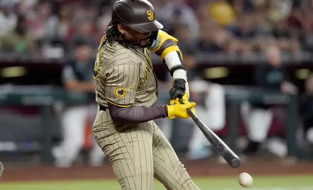 San Diego Padres' Luis Campusano connects for an RBI base hit against the Arizona Diamondbacks during the fourth inning of a baseball game, Saturday, May 4, 2024, in Phoenix. (AP Photo/Matt York)