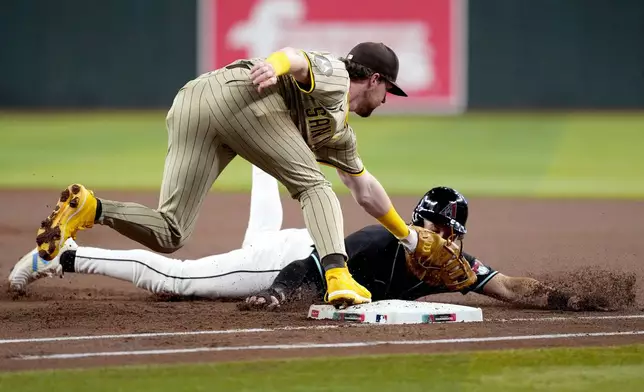 Arizona Diamondbacks' Jake McCarthy, right, is picked-off first by San Diego Padres pitcher Michael King as Jake Cronenworth makes the tag during the first inning of a baseball game, Saturday, May 4, 2024, in Phoenix. (AP Photo/Matt York)