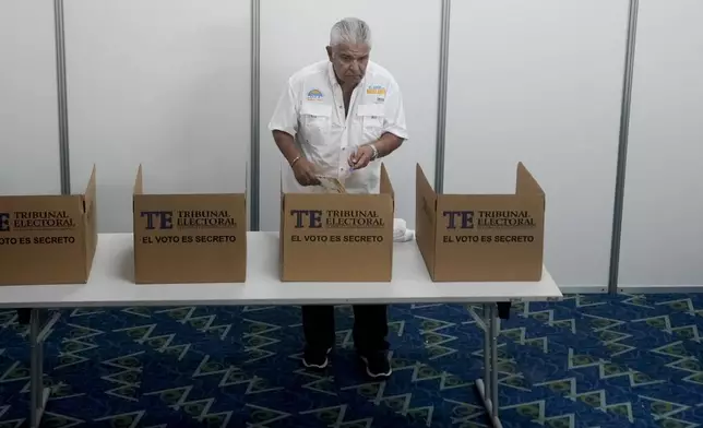 Achieving Goals presidential candidate Jose Raul Mulino holds his ballot during a general election in Panama City, Sunday, May 5, 2024. (AP Photo/Matias Delacroix)