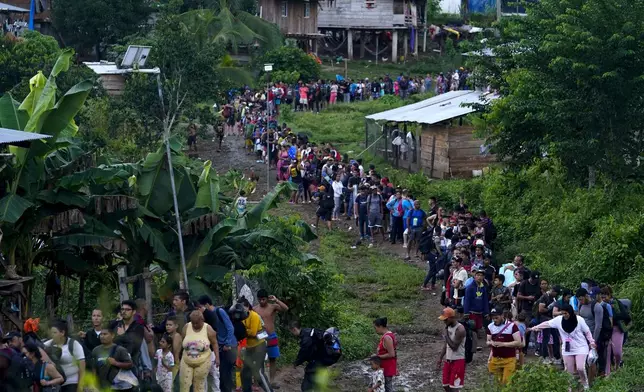 FILE - Migrants heading north line up to take a boat in Bajo Chiquito in the Darien province of Panama, Oct. 5, 2023, after walking across the Darien Gap from Colombia. Migration has increased through the Darien jungle, on the border with Colombia, where more than half a million people crossed last year. (AP Photo/Arnulfo Franco, File)