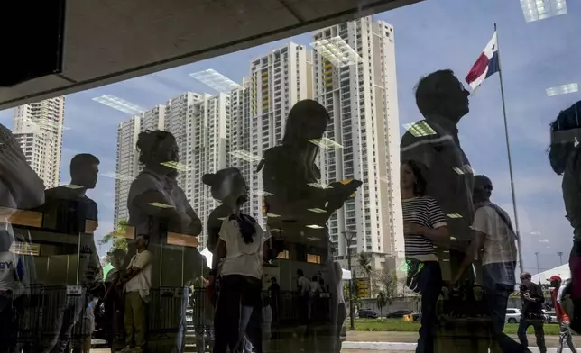 People line up to vote outside a polling station during a general election in Panama City, Sunday, May 5, 2024. (AP Photo/Matias Delacroix)