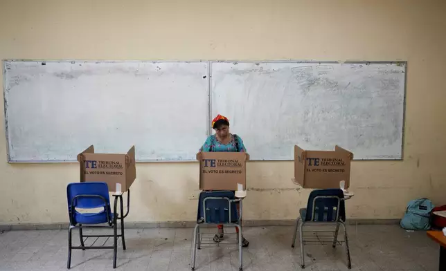 An Indigenous woman votes during a general election in Panama City, Sunday, May 5, 2024. (AP Photo/Matias Delacroix)
