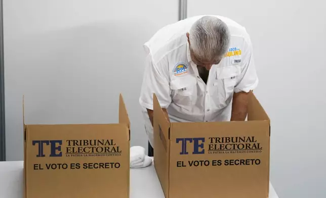 Achieving Goals presidential candidate Jose Raul Mulino marks his ballot as he chooses his preferences during a general election in Panama City, Sunday, May 5, 2024. (AP Photo/Matias Delacroix)