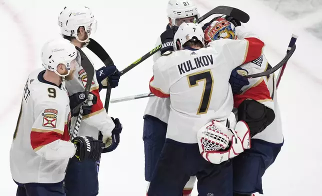 Florida Panthers' Dmitry Kulikov (7) and Nick Cousins (21) celebrate with Sergei Bobrovsky (72) in front of Sam Bennett (9) and Carter Verhaeghe (23) after defeating the Boston Bruins in Game 6 of an NHL hockey Stanley Cup second-round playoff series, Friday, May 17, 2024, in Boston. (AP Photo/Michael Dwyer)