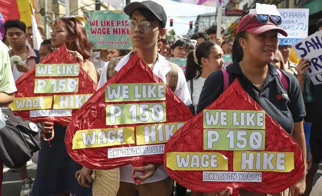 Filipino workers carry streamers and posters during a protest to mark International Labor Day near the presidential palace in Manila, Philippines on Wednesday, May 1, 2024. Hundreds of Filipino workers from various labor groups took to the streets to mark Labor Day and demand a wage increase and job security amid soaring food and oil prices. (AP Photo/Basilio Sepe)