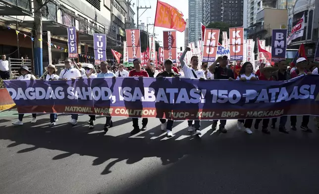 Filipino workers carry streamers and posters during a protest to mark International Labor Day near the presidential palace in Manila, Philippines on Wednesday, May 1, 2024. Hundreds of Filipino workers from various labor groups took to the streets to mark Labor Day and demand a wage increase and job security amid soaring food and oil prices. (AP Photo/Basilio Sepe)