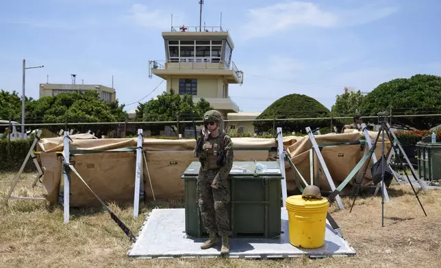 A U.S. soldier stands near the control tower at the Basco airport in Batanes province, northern Philippines on Monday, May 6, 2024. American and Filipino troopers are currently in the area to conduct annual combat-readiness exercises called Balikatan, Tagalog for shoulder-to-shoulder. (AP Photo/Aaron Favila)