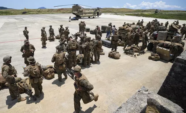 U.S. and Philippine marines wait at the airport of the Philippines' northernmost town of Itbayat, Batanes province during a joint military exercise on Monday, May 6, 2024. American and Filipino marines held annual combat-readiness exercises called Balikatan, Tagalog for shoulder-to-shoulder, in a show of allied military readiness in the Philippines' northernmost town facing southern Taiwan. (AP Photo/Aaron Favila)