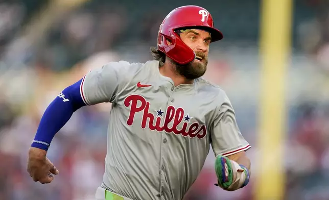 Philadelphia Phillies' Bryce Harper runs to third off a single by Alec Bohm during the first inning of a baseball game against the Los Angeles Angels, Tuesday, April 30, 2024, in Anaheim, Calif. (AP Photo/Ryan Sun)