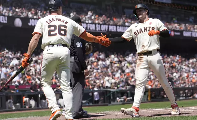 San Francisco Giants' Matt Chapman (26) celebrates with Patrick Bailey after they scored on teammate Mike Yastrzemski's two-run double during the second inning of a baseball game against the Philadelphia Phillies in San Francisco, Monday, May 27, 2024. (AP Photo/Jeff Chiu)