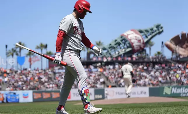 Philadelphia Phillies' Bryce Harper walks to the dugout after striking out against the San Francisco Giants during the first inning of a baseball game in San Francisco, Monday, May 27, 2024. (AP Photo/Jeff Chiu)