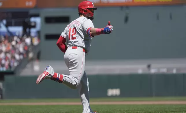 Philadelphia Phillies' Kyle Schwarber gestures to teammates after hitting a two-run home run against the San Francisco Giants during the third inning of a baseball game in San Francisco, Monday, May 27, 2024. (AP Photo/Jeff Chiu)