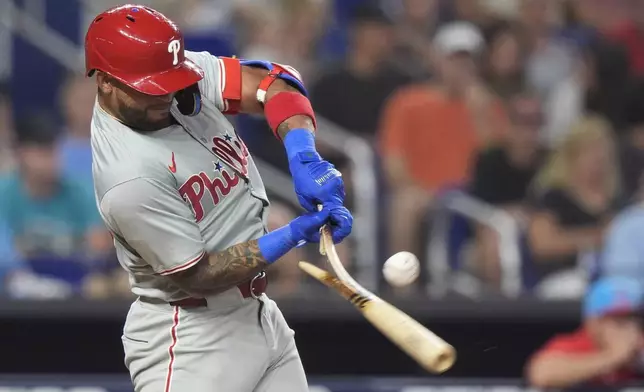 Philadelphia Phillies' Edmundo Sosa breaks his bat as he hits during the fifth inning of a baseball game against the Miami Marlins, Saturday, May 11, 2024, in Miami. (AP Photo/Wilfredo Lee)