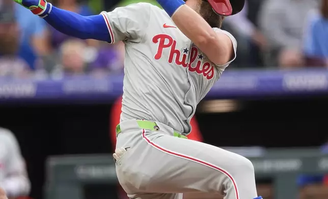 Philadelphia Phillies' Bryce Harper strikes out against Colorado Rockies starting pitcher Ty Blach to end the top of the first inning of a baseball game Friday, May 24, 2024, in Denver. Harper was ejected for arguing strikes with home plate umpire Brian Walsh. (AP Photo/David Zalubowski)