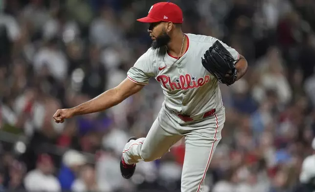 Philadelphia Phillies relief pitcher Seranthony Domínguez works against the Colorado Rockies in the seventh inning of a baseball game Saturday, May 25, 2024, in Denver. (AP Photo/David Zalubowski)