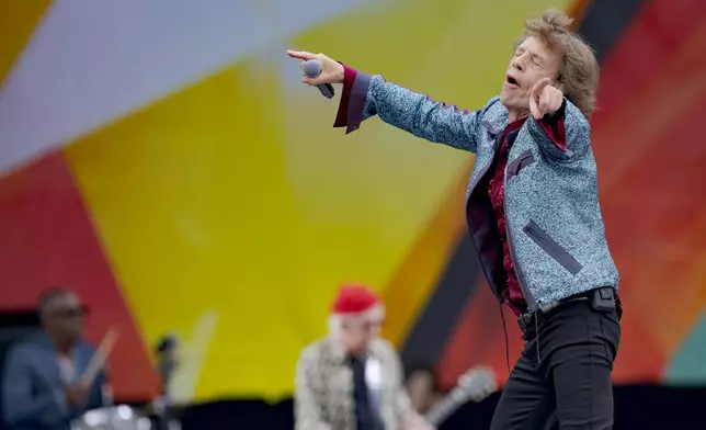 Mick Jagger, right, and Keith Richards, center background, of the Rolling Stones, perform during the New Orleans Jazz and Heritage Festival in New Orleans, Thursday, May 2, 2024. (AP Photo/Matthew Hinton)