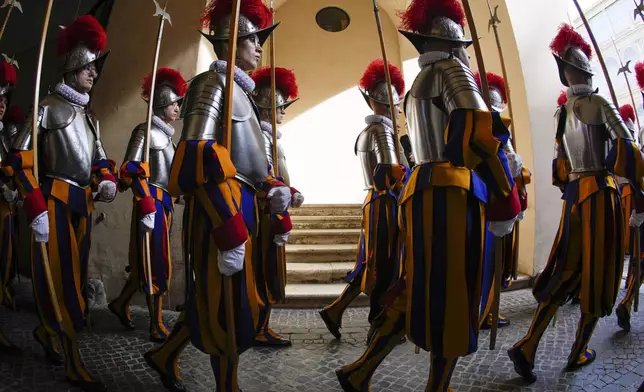 Vatican Swiss Guard recruits march during their swearing-in ceremony, at the Vatican, Monday, May 6, 2024. The ceremony is held each May 6 to commemorate the day in 1527 when 147 Swiss Guards died protecting Pope Clement VII during the Sack of Rome. (AP Photo/Andrew Medichini)