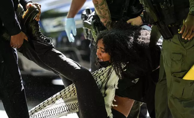 Authorities detain a protester on the campus of Emory University during a pro-Palestinian demonstration, in Atlanta, Georgia, April 25, 2024. (AP Photo/Mike Stewart)