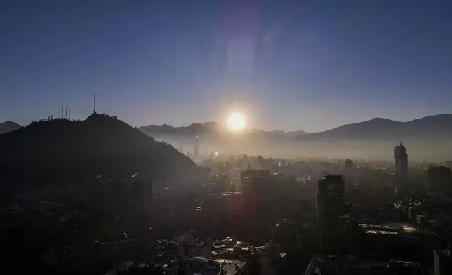The sun rises over the snow-blanketed Andes in Santiago, Chile, May 8, 2024. (AP Photo/Esteban Felix)
