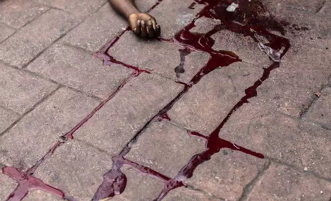 The body of a man shot dead lies in a pool of blood in the Petion-Ville neighborhood of Port-au-Prince, Haiti, May 3, 2024. (AP Photo/Ramon Espinosa)